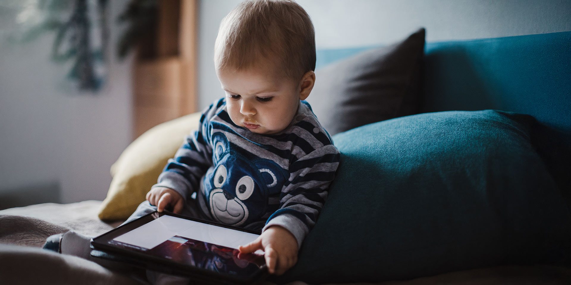 baby stares in the digital tablet