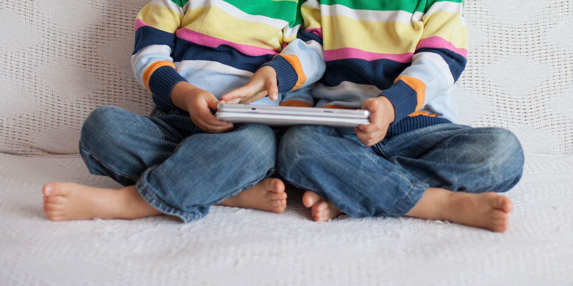 t brothers, playing on tablet