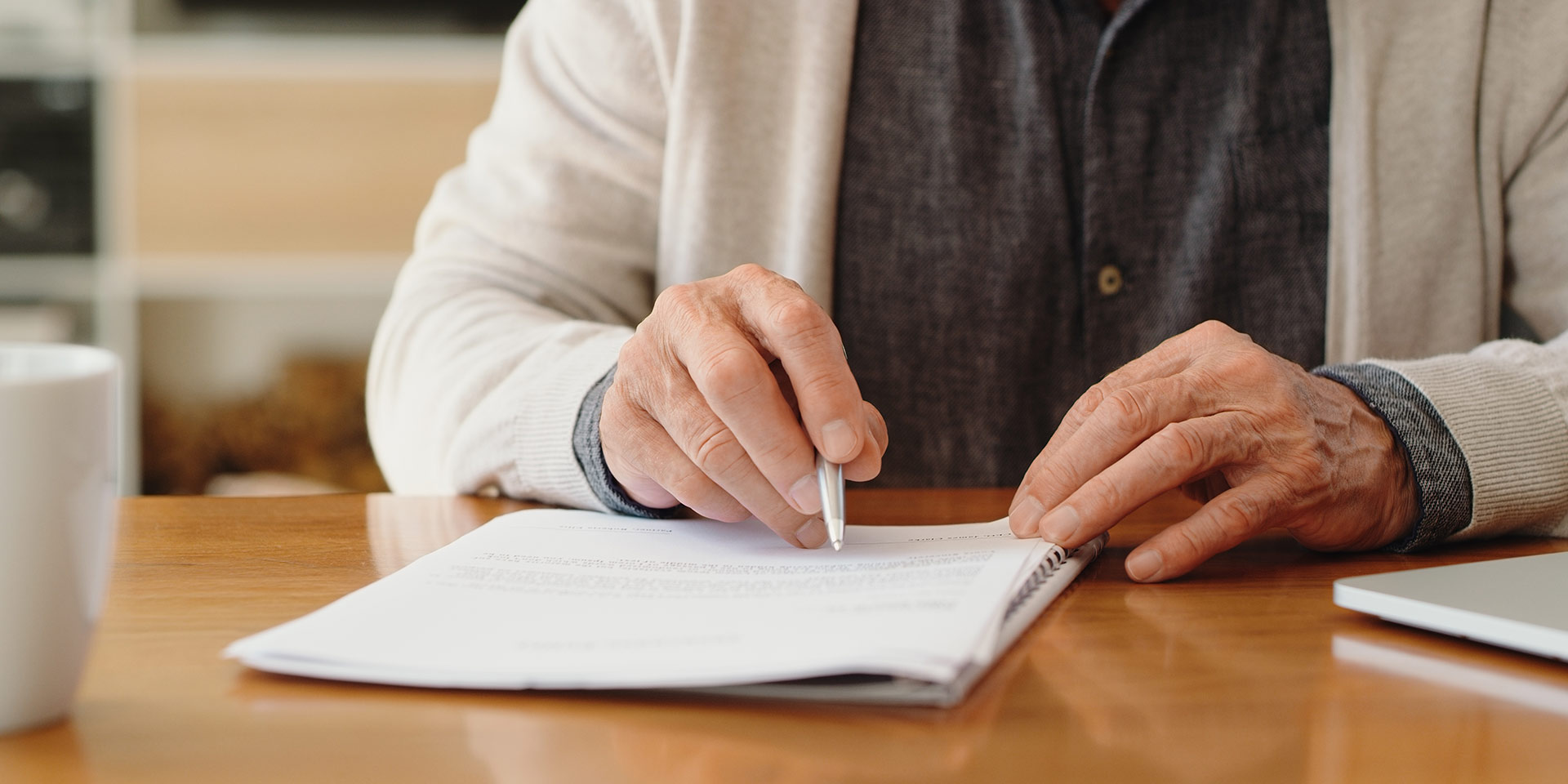 hands of senior retirement man writing a finance savings budget plan on paper or legal trust f for after her funeral. elly person apply for pension or government financial support and help