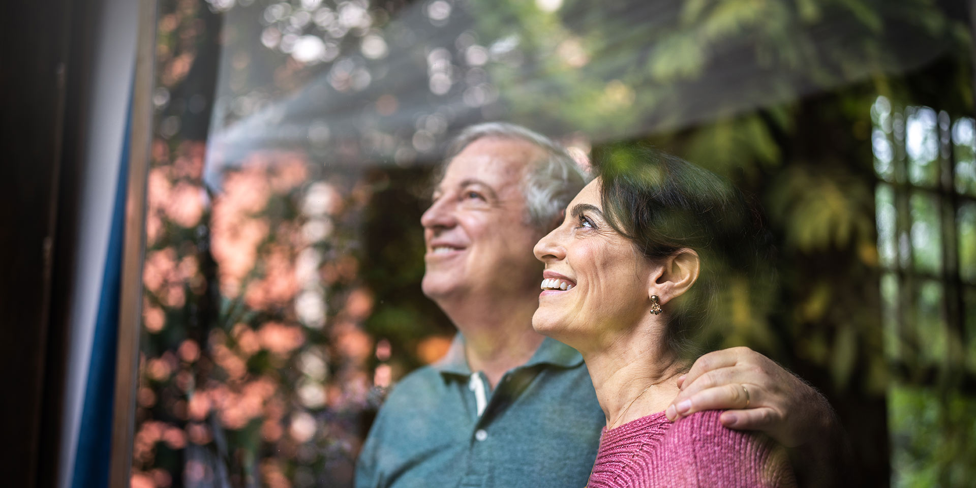 senior couple looking through window